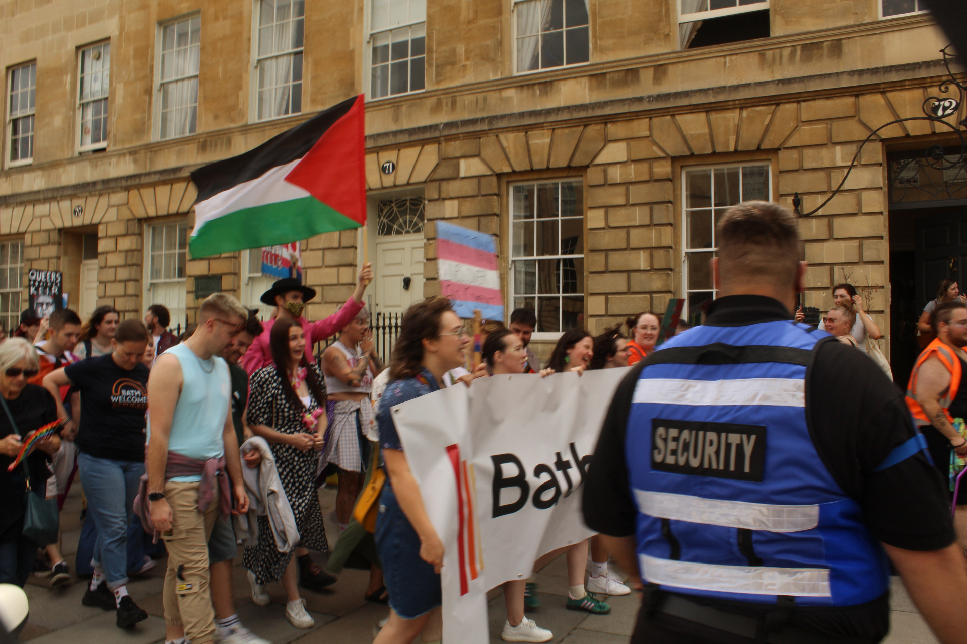 AV Group UK stewards escorting the Bath Pride parade banner through the crowd