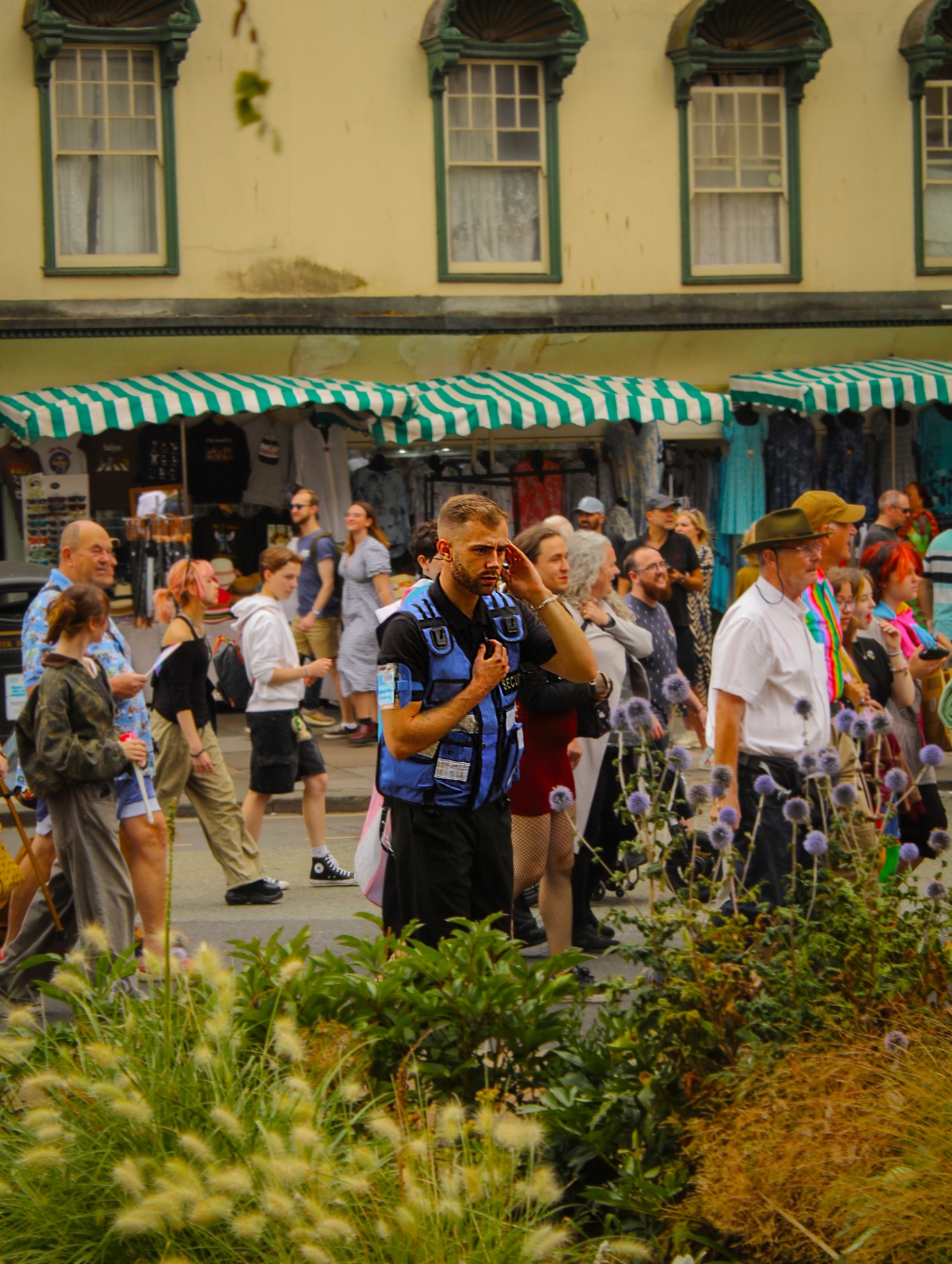 Officer controlling crowd flow along a Georgian Bath street during a public event
